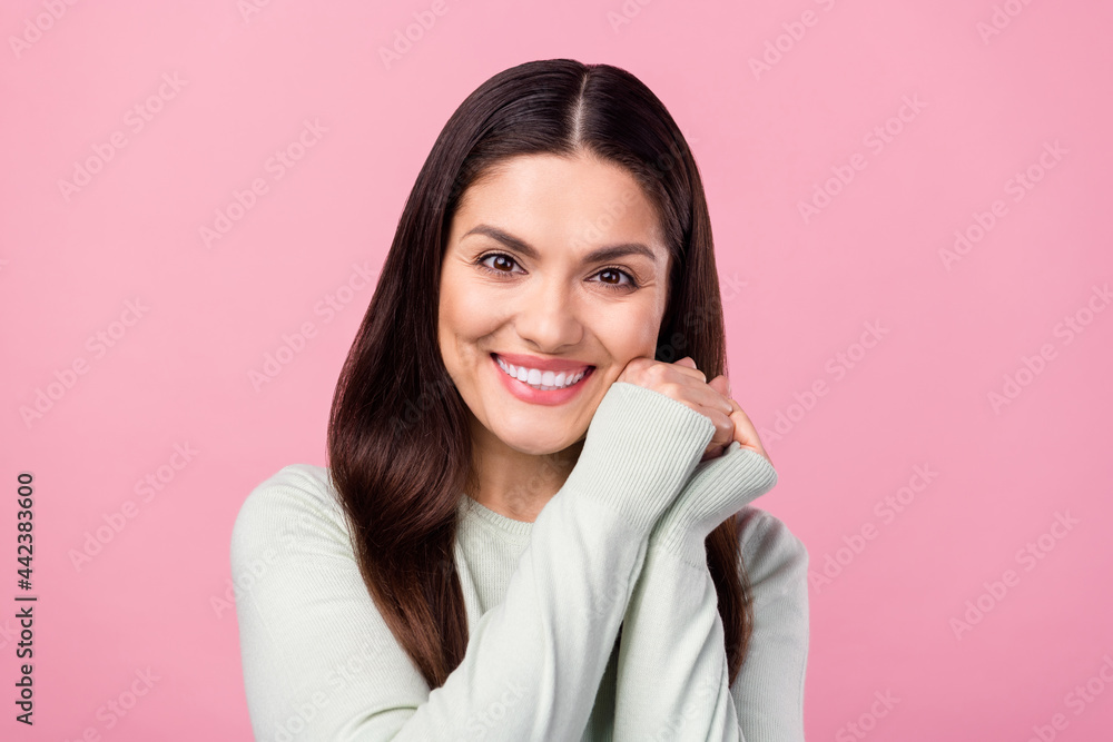 Photo of adorable nice positive woman smile good mood hold hands face isolated on pink color background Photo of adorable nice positive woman smile good mood hold hands face isolated on pink color background