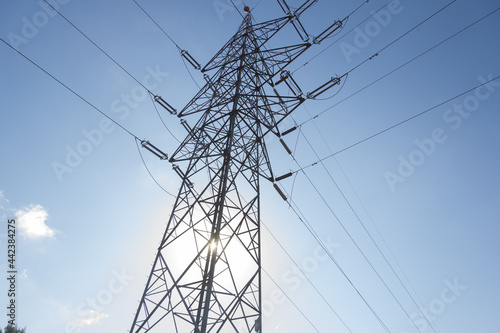 Power lines during a beautiful sunset. Electricity transportation on beautiful landscapes of the world.