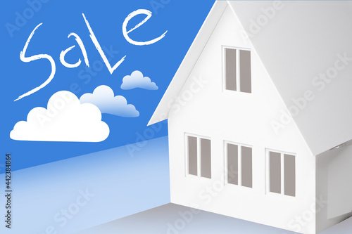 Sale house illustration. White mock house on a blue background. Sale lettering as a metaphor for real estate business. House is put up for sale by a realtor. 3d home as a symbol of immovability photo