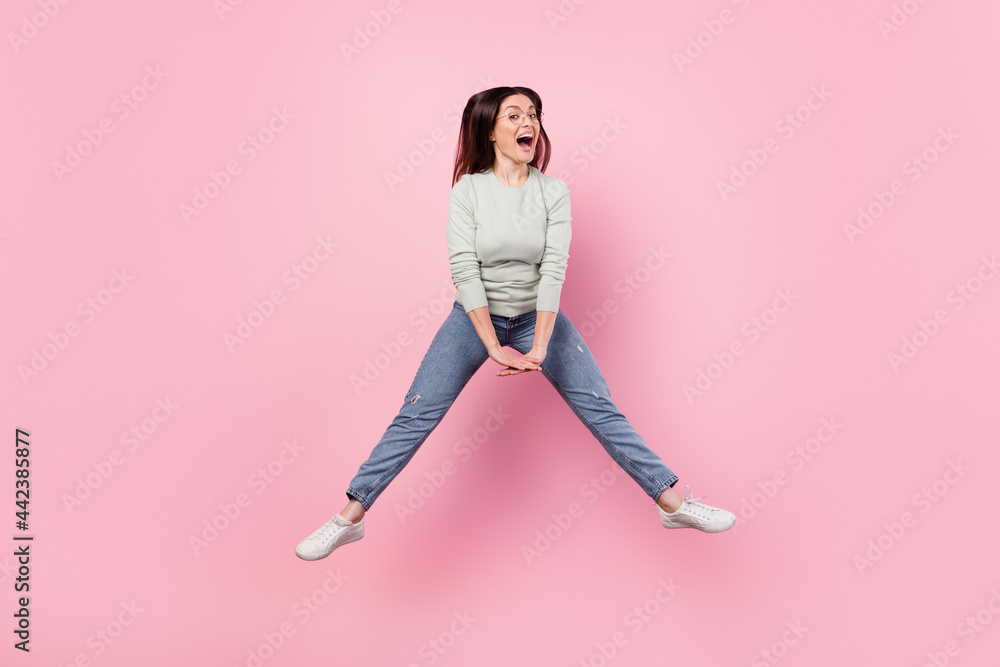 Full length photo of crazy happy nice mature lady jump up good mood sport isolated on pink color background