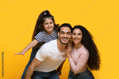 Family Time. Portrait Of Happy Arab Parents And Daughter Having Fun Together