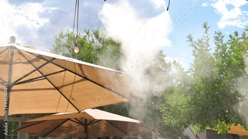 Artificial mist created by an outdoor cooling system