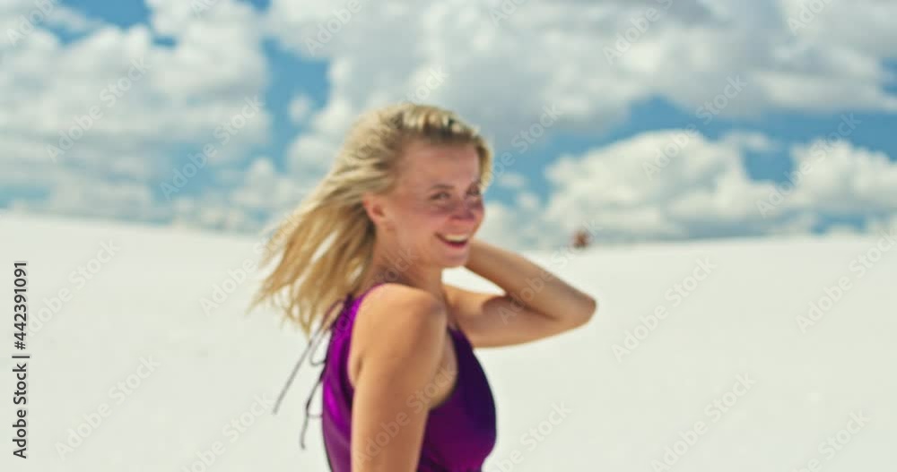 Cinematic slow motion of a woman walking on a sand dune. Barefoot woman traveler in a dress swinging in the wind on the undulating surface of the sandy desert with a cloud in the background. 4K Scenic Cinematic slow motion of a woman walking on a sand dune. Barefoot woman traveler in a dress swinging in the wind on the undulating surface of the sandy desert with a cloud in the background. 4K Scenic