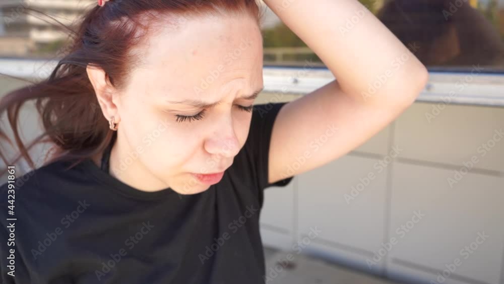 Close up of young woman got sunstroke in hot weather. Unhappy female feeling unwell on street in summertime Close up of young woman got sunstroke in hot weather. Unhappy female feeling unwell on street in summertime