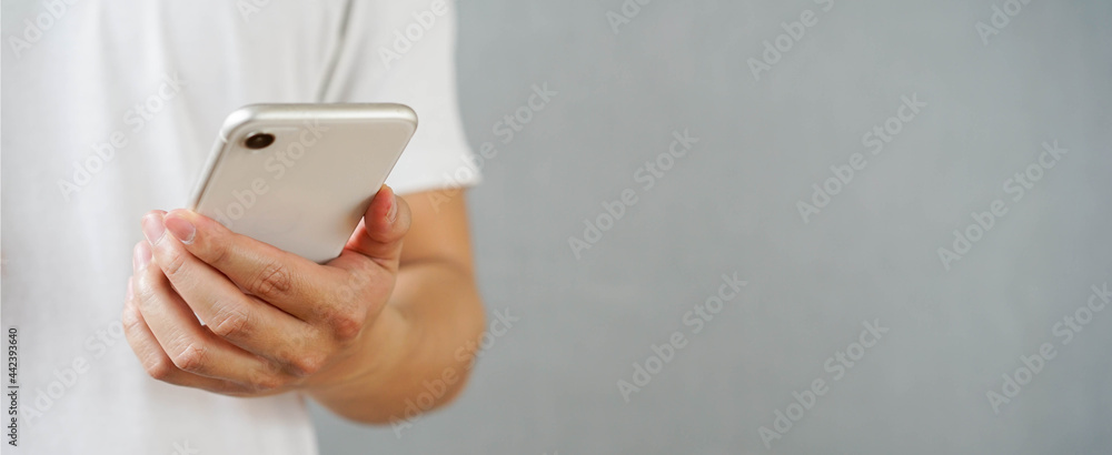 close up man hand hold mobile cell phone device for surf the internet or check news or play social media network application in relax time concept close up man hand hold mobile cell phone device for surf the internet or check news or play social media network application in relax time concept
