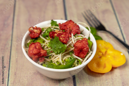 mouth watering gobi noodles with coriander and capsicum