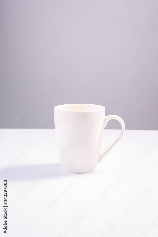 empty white cup on white gray background minimalistic concept empty white cup on white gray background minimalistic concept