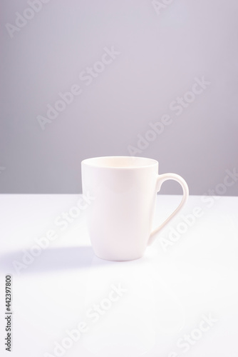 empty white cup on white gray background minimalistic concept