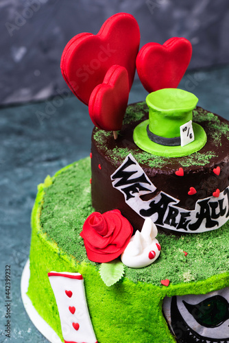 Green cake Alice in wonderland with mastic sweet hat photo