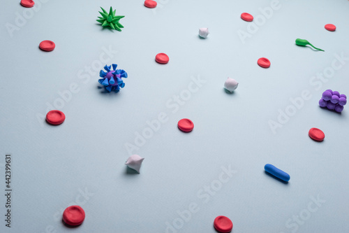 Fototapeta Naklejka Na Ścianę i Meble -  viruses in the blood. Medical flatlay of blood poisoning with viruses and bacteria on a blue background. View from above