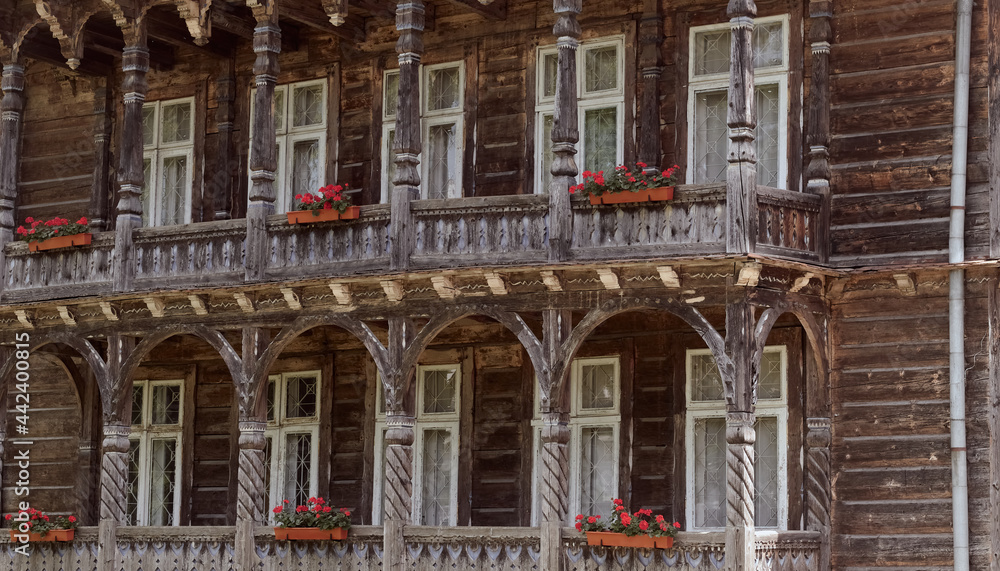 Wooden old facade of the house. Facade of the old log house in the of wooden architecture.