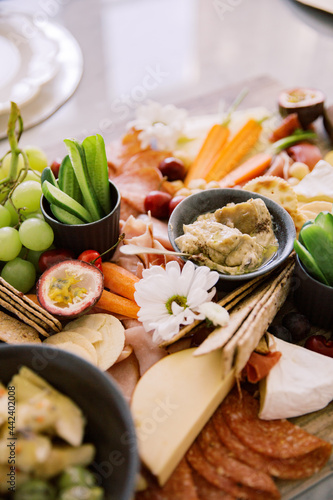 Close up photo of grapes, dragon fruit, cucumber, cheese, ham, fruits and vegetables photo