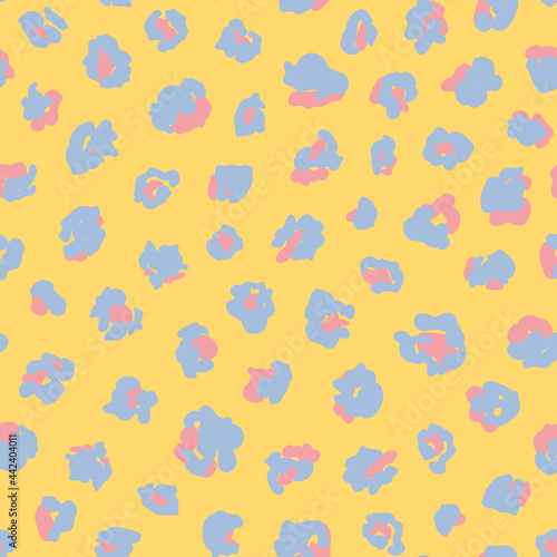 Abstract leo seamless repeat pattern. Random placed, fun, vector animal all over surface print on yellow background.