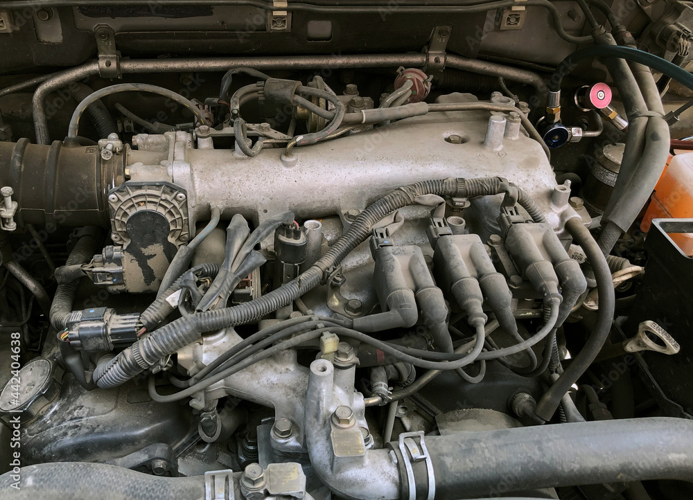 Car gasoline engine. Car engine part. Close-up photo of an internal combustion engine. Engine detailing in a used car. Car gasoline engine. Car engine part. Close-up photo of an internal combustion engine. Engine detailing in a used car.