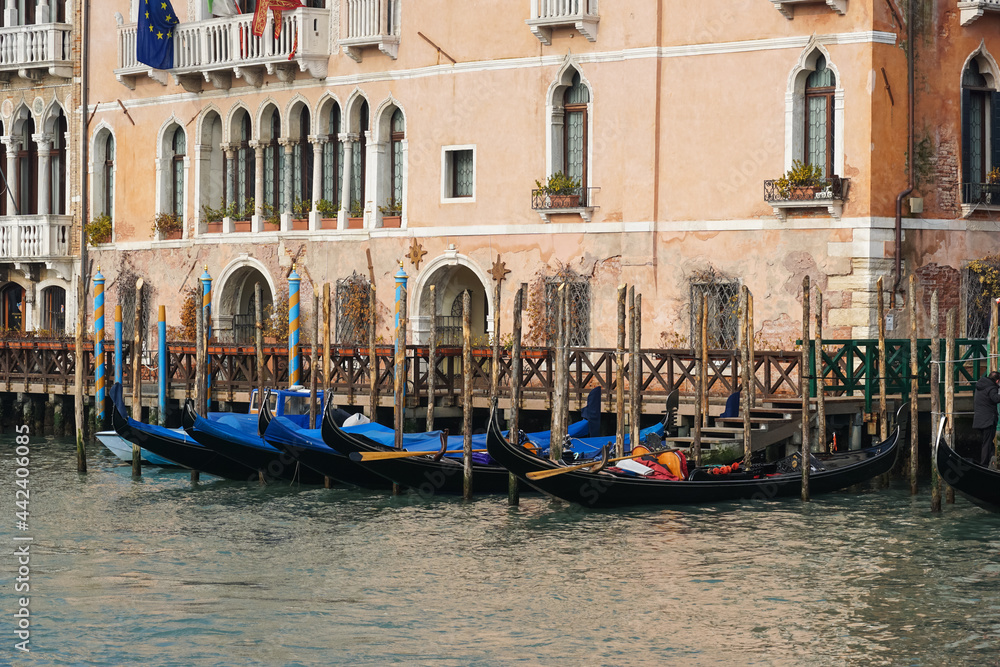 Traditional Venetian gondolas moored on Grand Canal in Venice, Italy