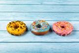 Delicious assorted colorful donuts on the table.