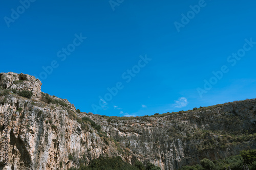 Scenic landscape of white rock at sunny summer day. Beautiful nature in Greece. Huge mountain.