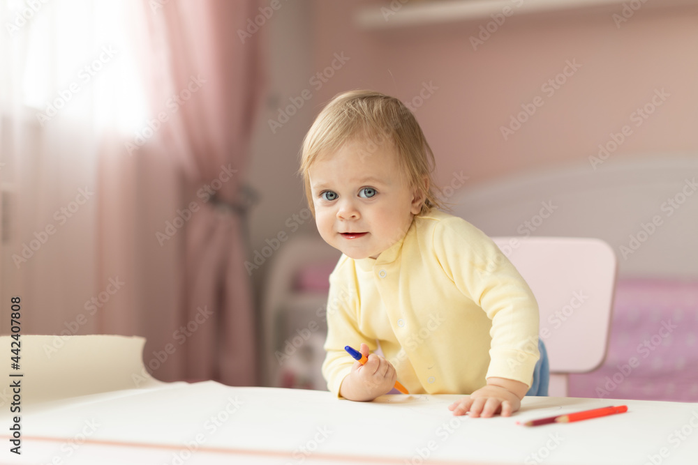 Baby draws at the table Baby draws at the table