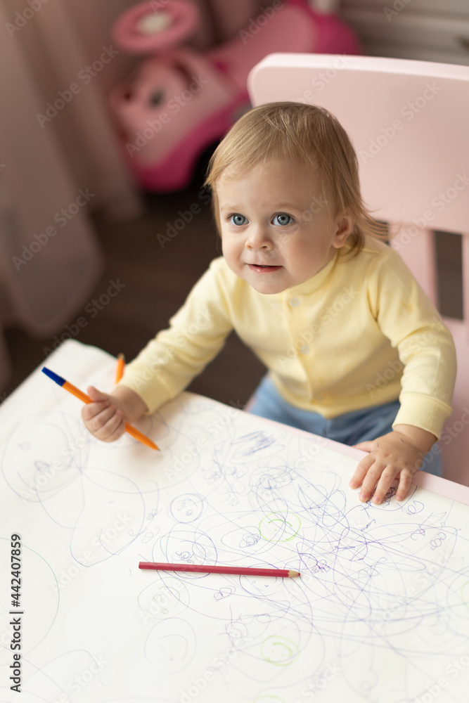 Baby draws at the table Baby draws at the table