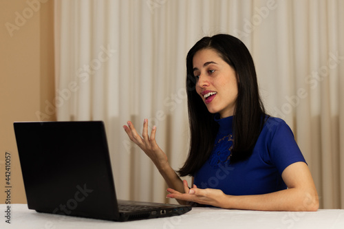 woman working on laptop. Person talking on the computer, laptop. giving classes, exposing. virtual. isolated. Latin woman