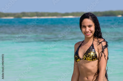 Enjoying the summer in the Venezuelan Caribbean. Beach girl enjoys crystal clear waters, Chichiriviche, Cayo Muerto - Morrocoy National Park photo