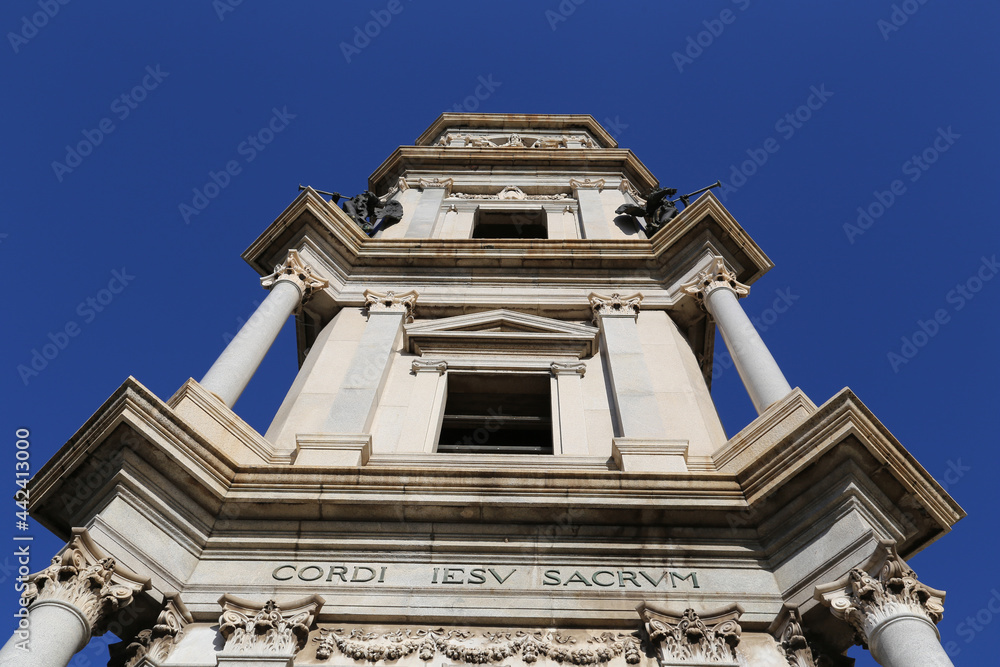 Low angle view of the bell tower of Pontifical Shrine of the Blessed Virgin of the Rosary of Pompeii (Pompei Cathedral) against a suggestive blue sky. Naples, Italy.