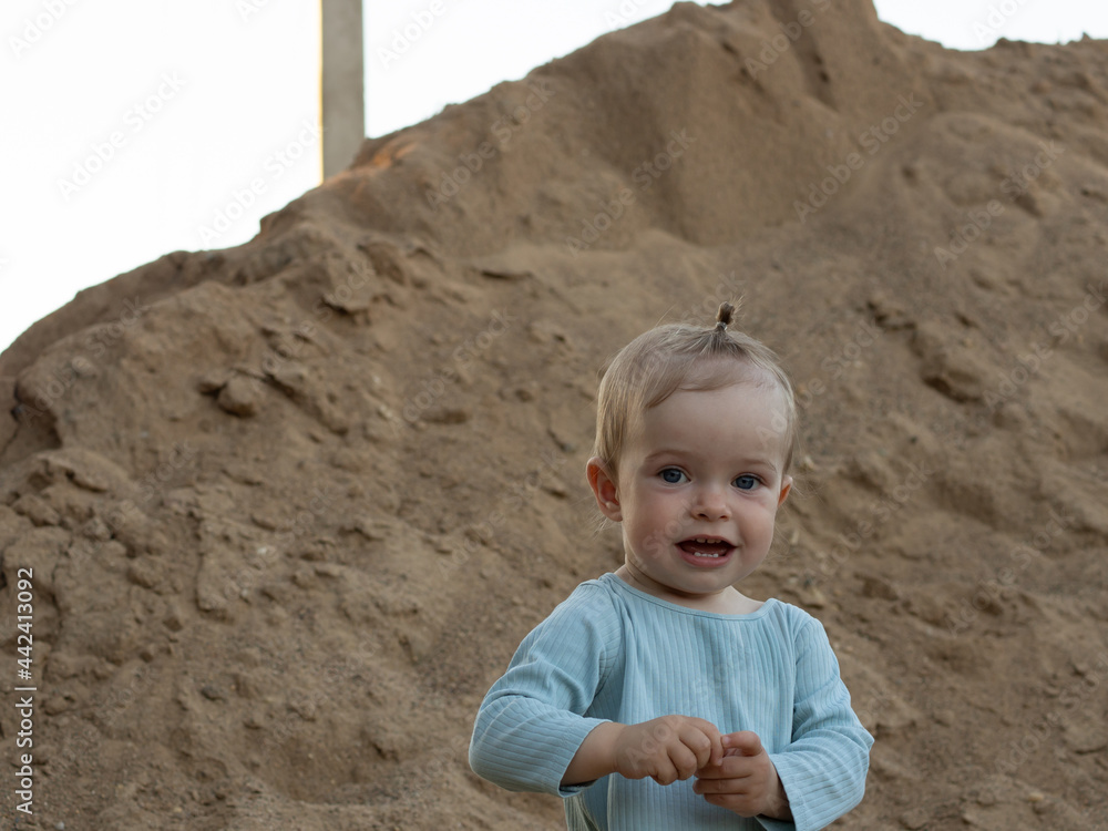 beautiful one year old girl playing in the sand beautiful one year old girl playing in the sand