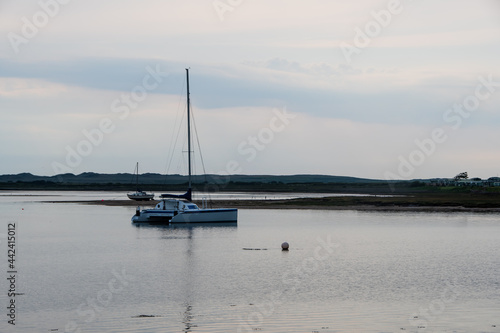 A Catamaran in an estuary at sunset