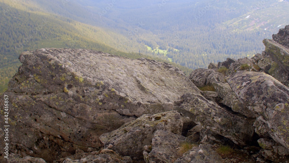 The rock is sticking out of the mountain. Place of extraction of building material. Mountain range. The rock is sticking out of the mountain. Place of extraction of building material. Mountain range.