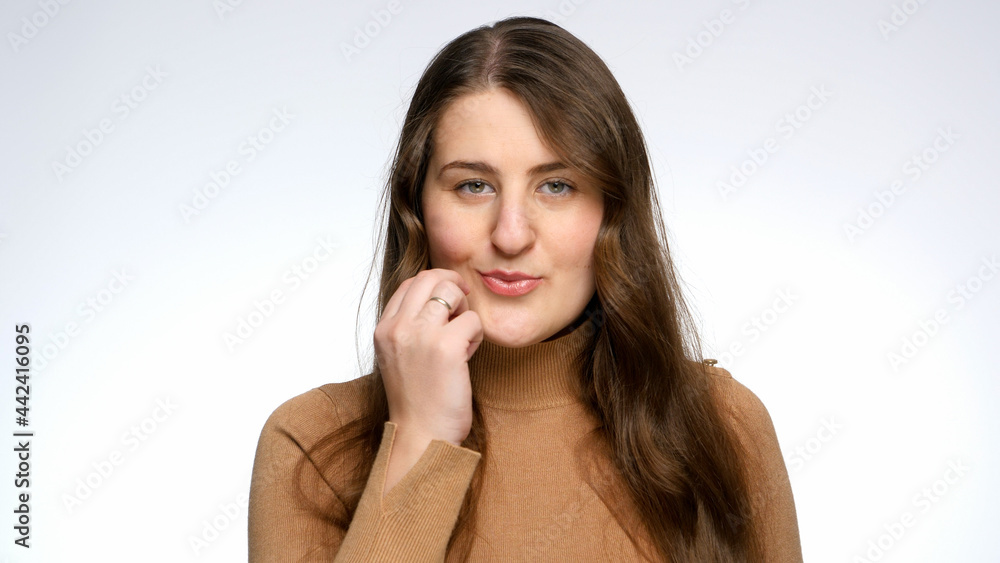Studio portrait of young woman locking her mouth with invisible lock and throwing away key. Concept of keeping secret and silence. Studio portrait of young woman locking her mouth with invisible lock and throwing away key. Concept of keeping secret and silence.
