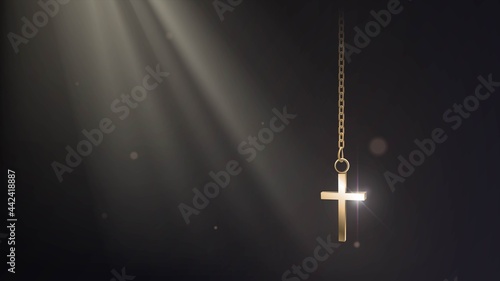 Golden cross on a chain in a dark room in the rays of the sun, religion and christianity concept