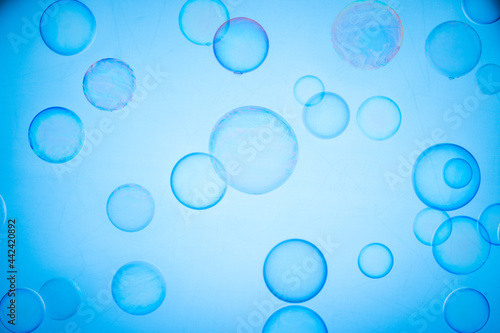 Soap translucent bubbles on a light backdrop  abstract background