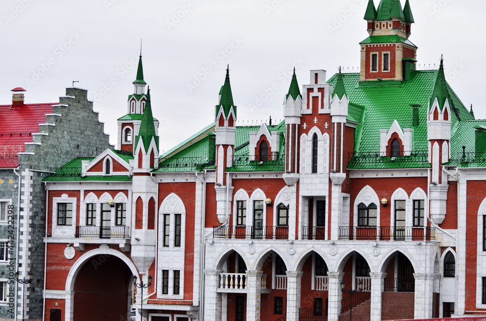 The building of the wedding palace is in the Dutch style of red and white brick with a green roof. Russia Yoshkar-Ola 01.05.2021. High quality photo