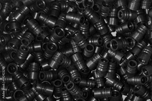 Lots of plastic black fittings for connecting water pipes or plastic pipes. Background, texture. Industrial equipment.