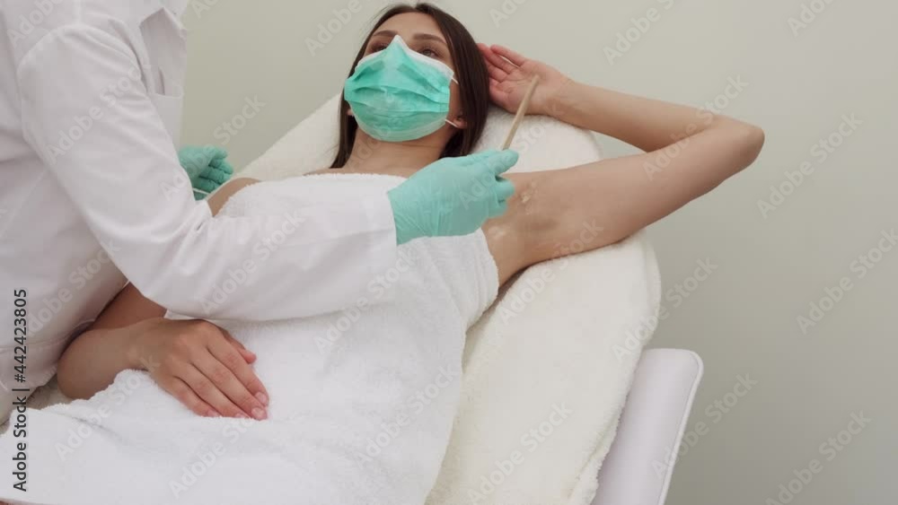 Cosmetology. Beautician removes armpit hair. Armpit laser hair removal. Beauty clinic. Epilation and spa. Body care. Cosmetology. Beautician removes armpit hair. Armpit laser hair removal. Beauty clinic. Epilation and spa. Body care.