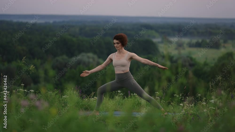 Young woman preforms yoga in mountains in morning light. Woman performs yoga moves on mountain summit. Serenity and yoga practicing at mountain range,meditation Young woman preforms yoga in mountains in morning light. Woman performs yoga moves on mountain summit. Serenity and yoga practicing at mountain range,meditation