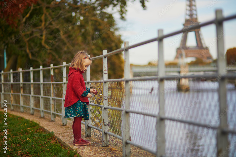 Adorable toddler girl playing in autumn park Adorable toddler girl playing in autumn park