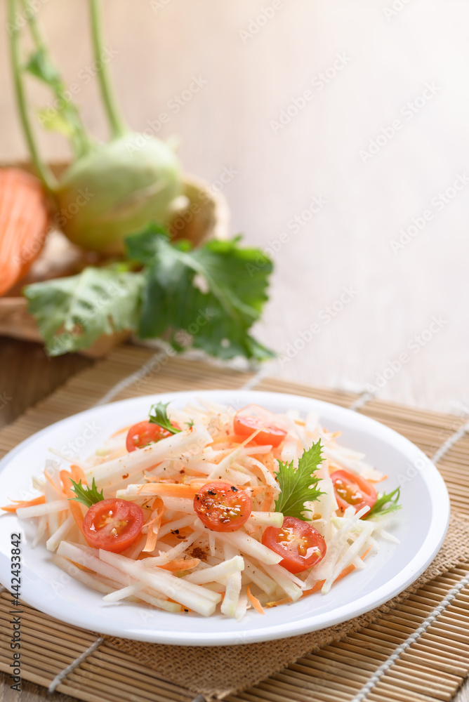Salad with sliced kohlrabi, carrot, tomato and mizuna leaf on white dish, Vegan food, Healthy eating Salad with sliced kohlrabi, carrot, tomato and mizuna leaf on white dish, Vegan food, Healthy eating