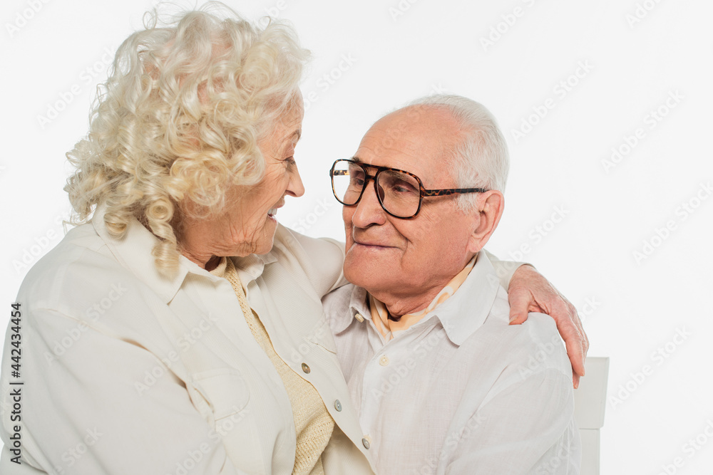 happy elderly couple gently hugging isolated on white happy elderly couple gently hugging isolated on white