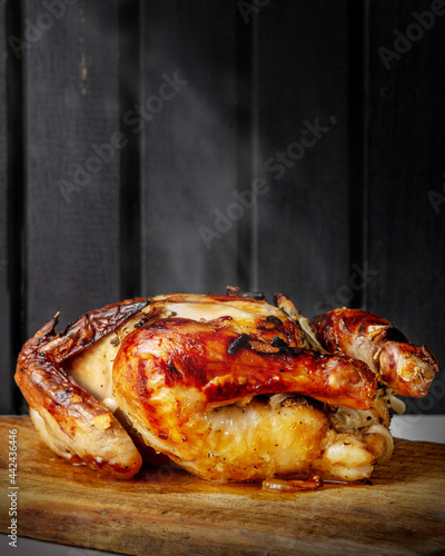 Wallpaper Mural Oven Baked whole crispy chicken on top of a wooden cutting board seasoned with garlic and onions Torontodigital.ca