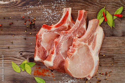 Pork cut meat chop with bay leaf and red pepper. photo