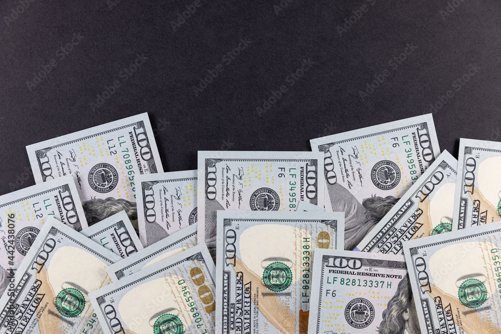 US 100 dollar banknotes on black background US 100 dollar banknotes on black background