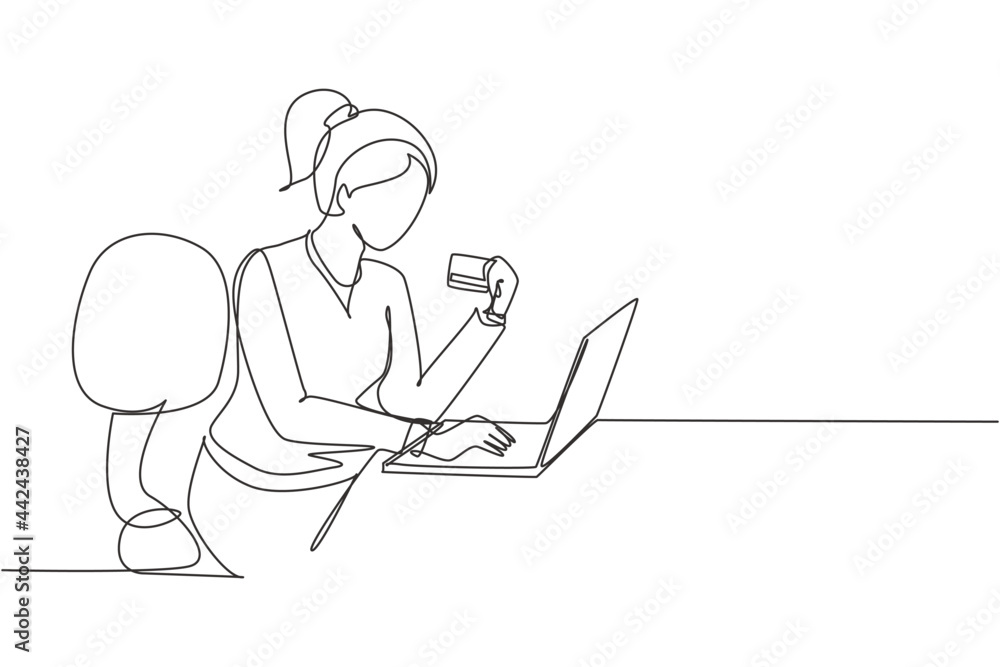 Single one line drawing young woman sitting on chair and typing entering credit card code on laptop around desk. Digital payment concept. Modern continuous line draw design graphic vector illustration