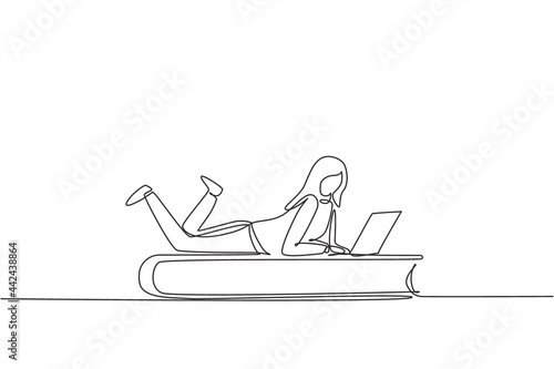 Single one line drawing young female with laptop laying down on big book. Freelance, distance learning, online courses, studying concept. Modern continuous line draw design graphic vector illustration