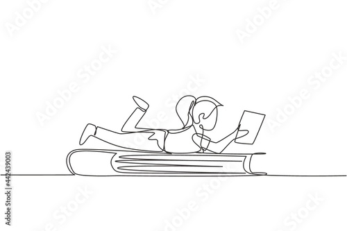 Continuous one line drawing little girl reading, learning and laying down on big book. Study in library. Smart student, education concept, fair. Single line draw design vector graphic illustration