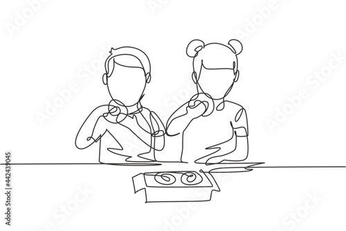 Continuous one line drawing two boy and girl having donuts meal with hand around table. Happy and enjoy breakfast at home. Tasty and healthy food. Single line draw design vector graphic illustration