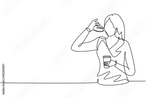 Single one line drawing young woman having donut meal and drink cup of coffee with hand. Enjoy breakfast. Delicious and healthy food. Modern continuous line draw design graphic vector illustration