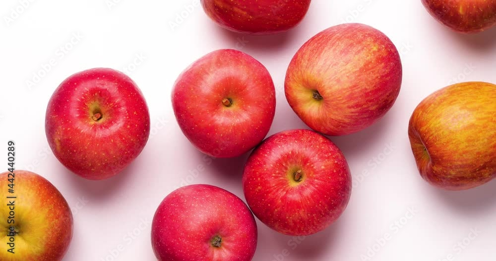 Video of a red apple slowly turning on a White background, shot from directly above. Video of a red apple slowly turning on a White background, shot from directly above.