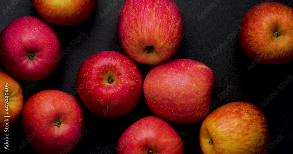 Video of a red apple slowly turning on a Black background, shot from directly above. Video of a red apple slowly turning on a Black background, shot from directly above.