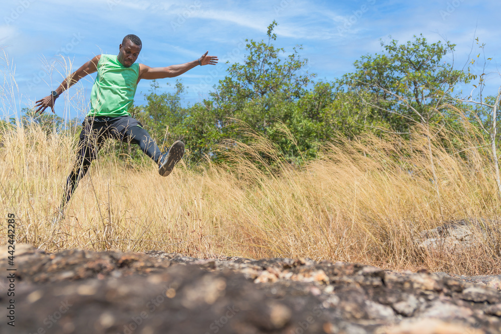 female trail runner jumping on running on trail on mountain in summer female trail runner jumping on running on trail on mountain in summer